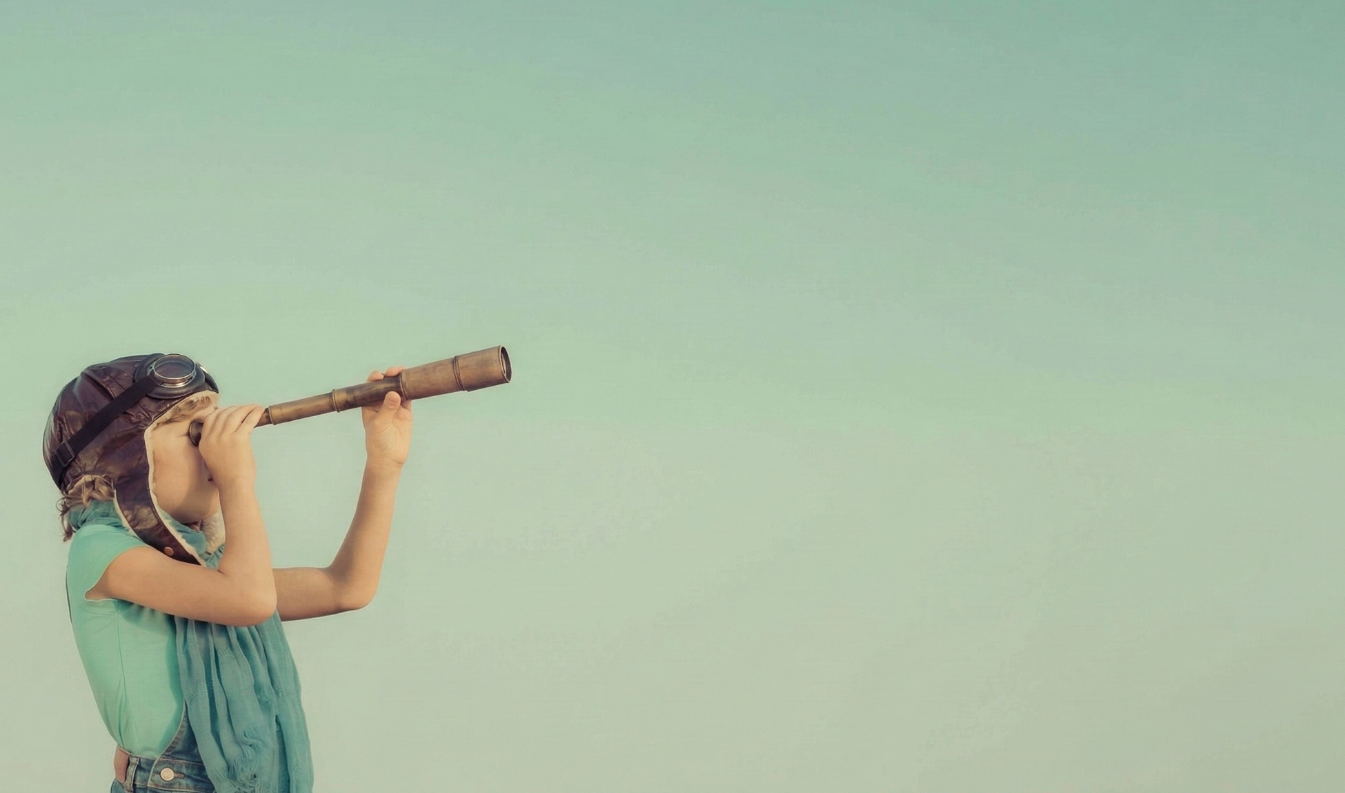 A child in a leather aviator cap holds a brass telescope up to their eye, scanning a pale sage sky.